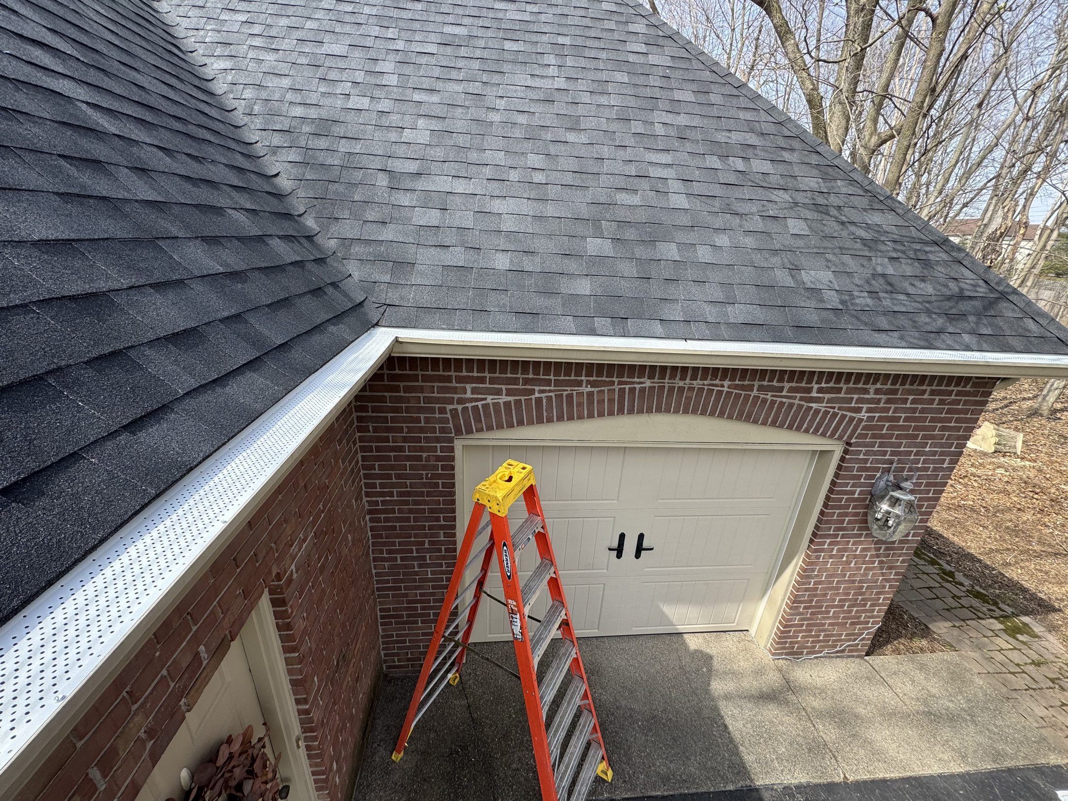 Wide installed Bryant gutter guard run on a brick garage