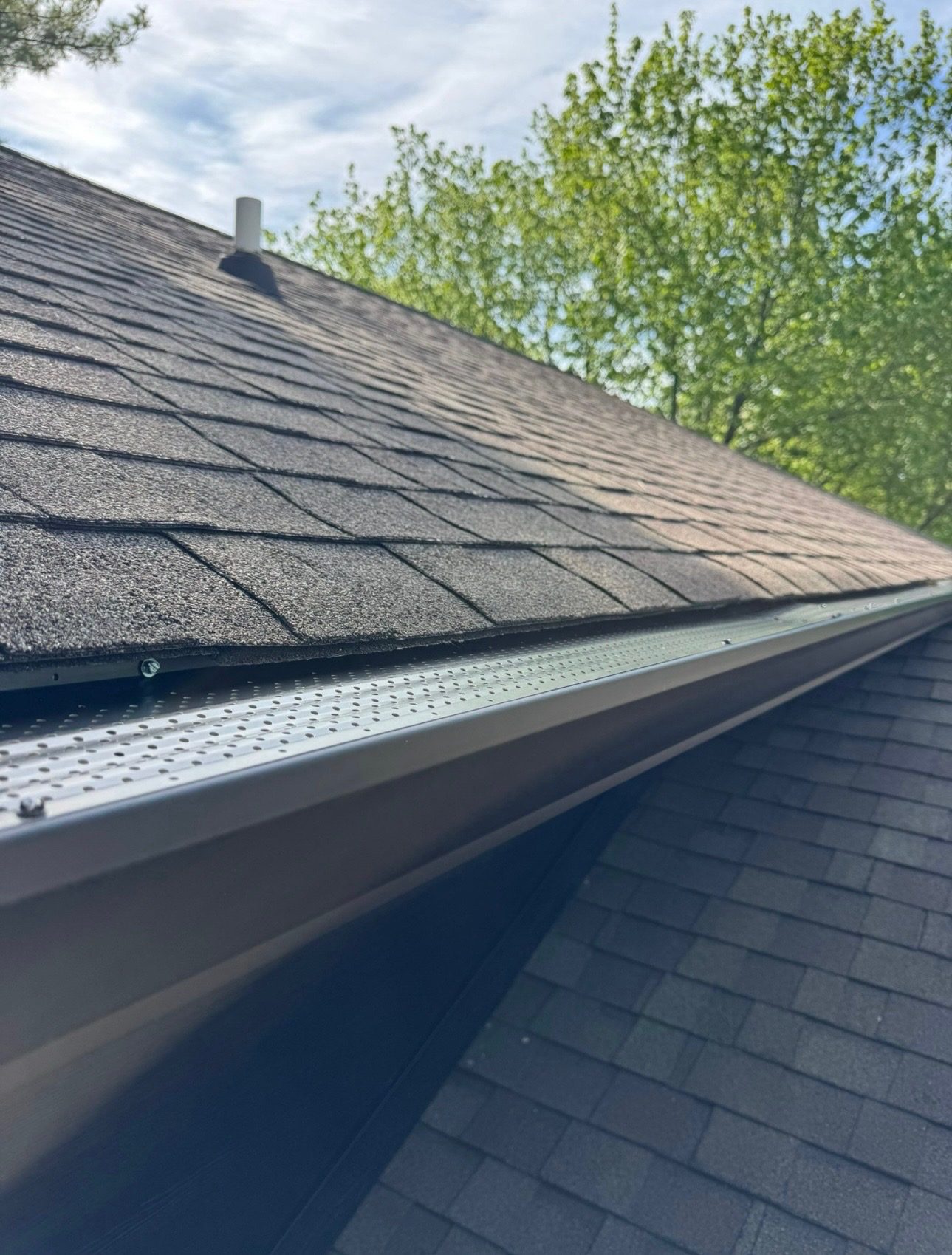 Close-up of Bryant's installed gutter protection along a roof edge