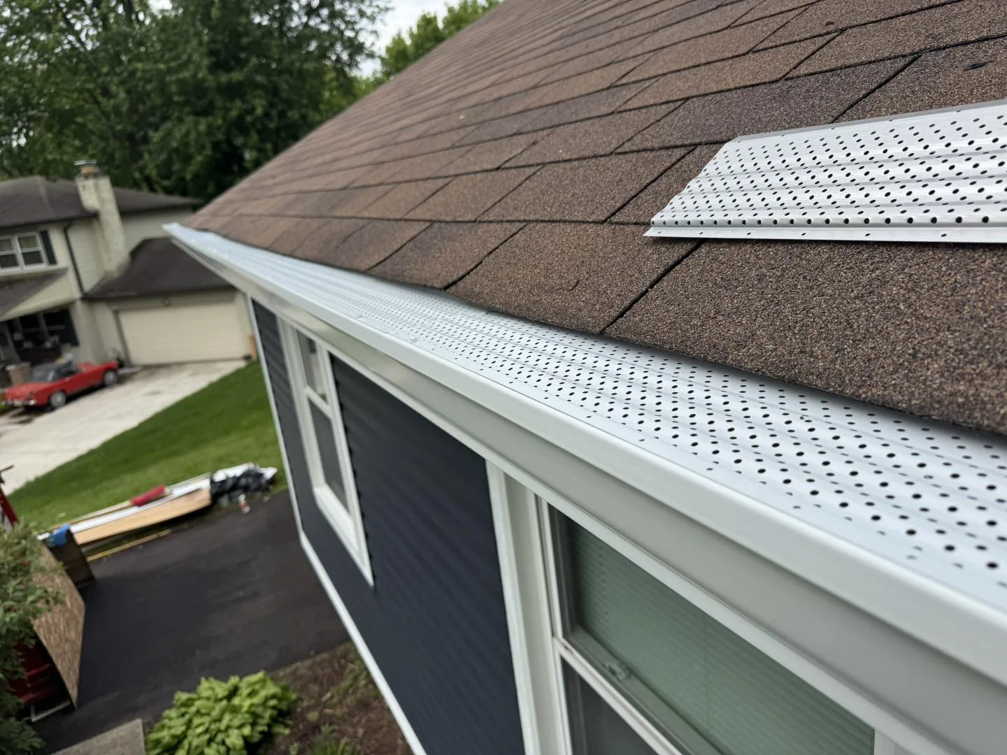 Installed gutter guard close-up on shingles