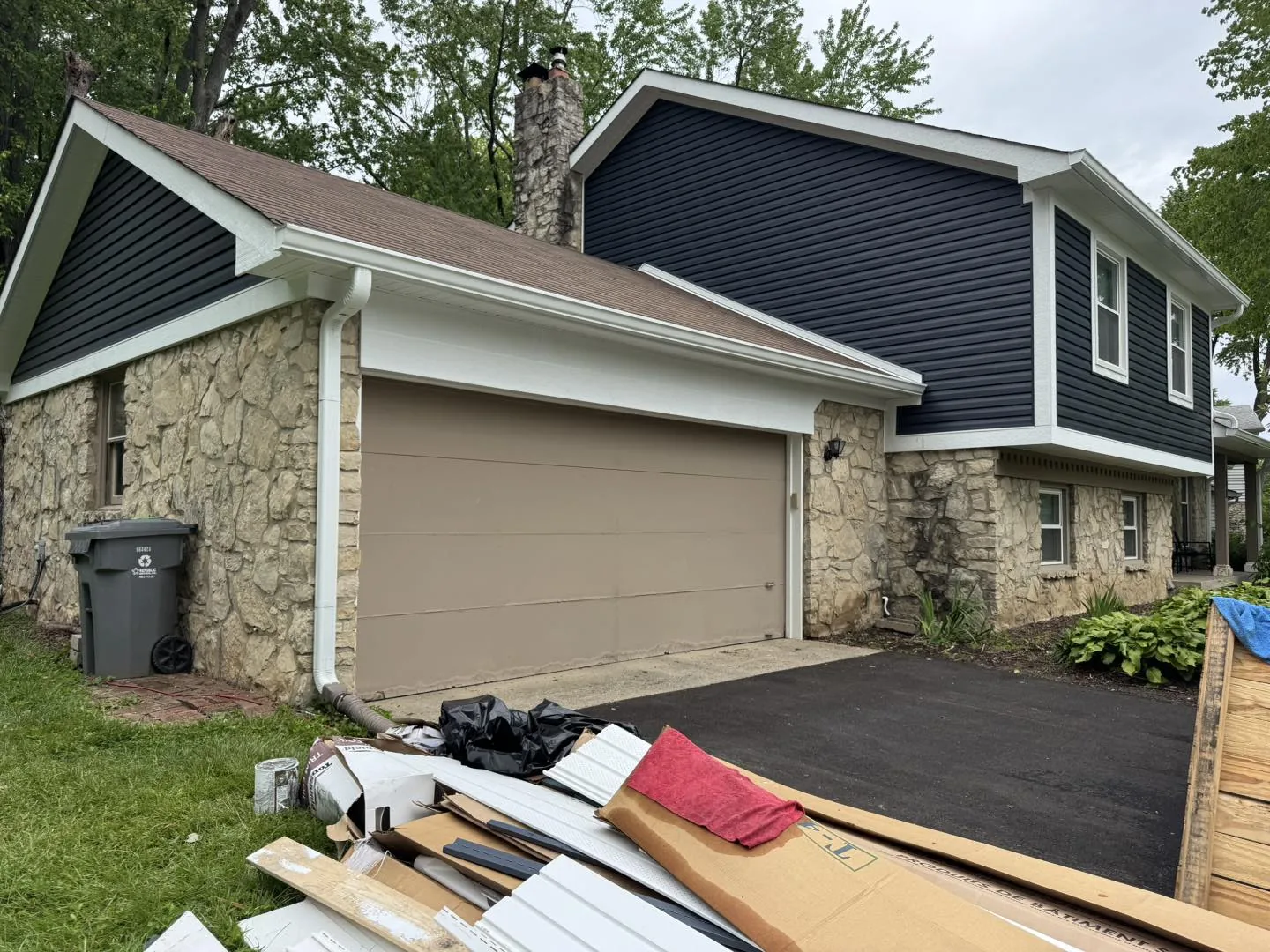 Screened porch gutter project with ladders staged