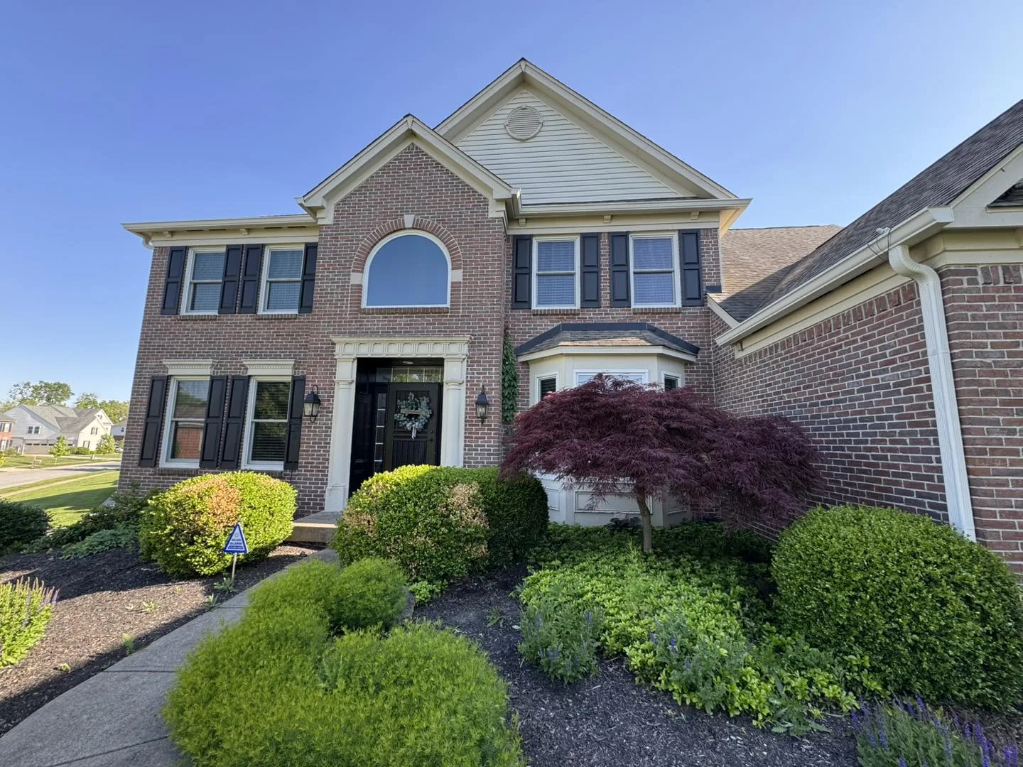 Finished brick home front exterior with Bryant gutter work